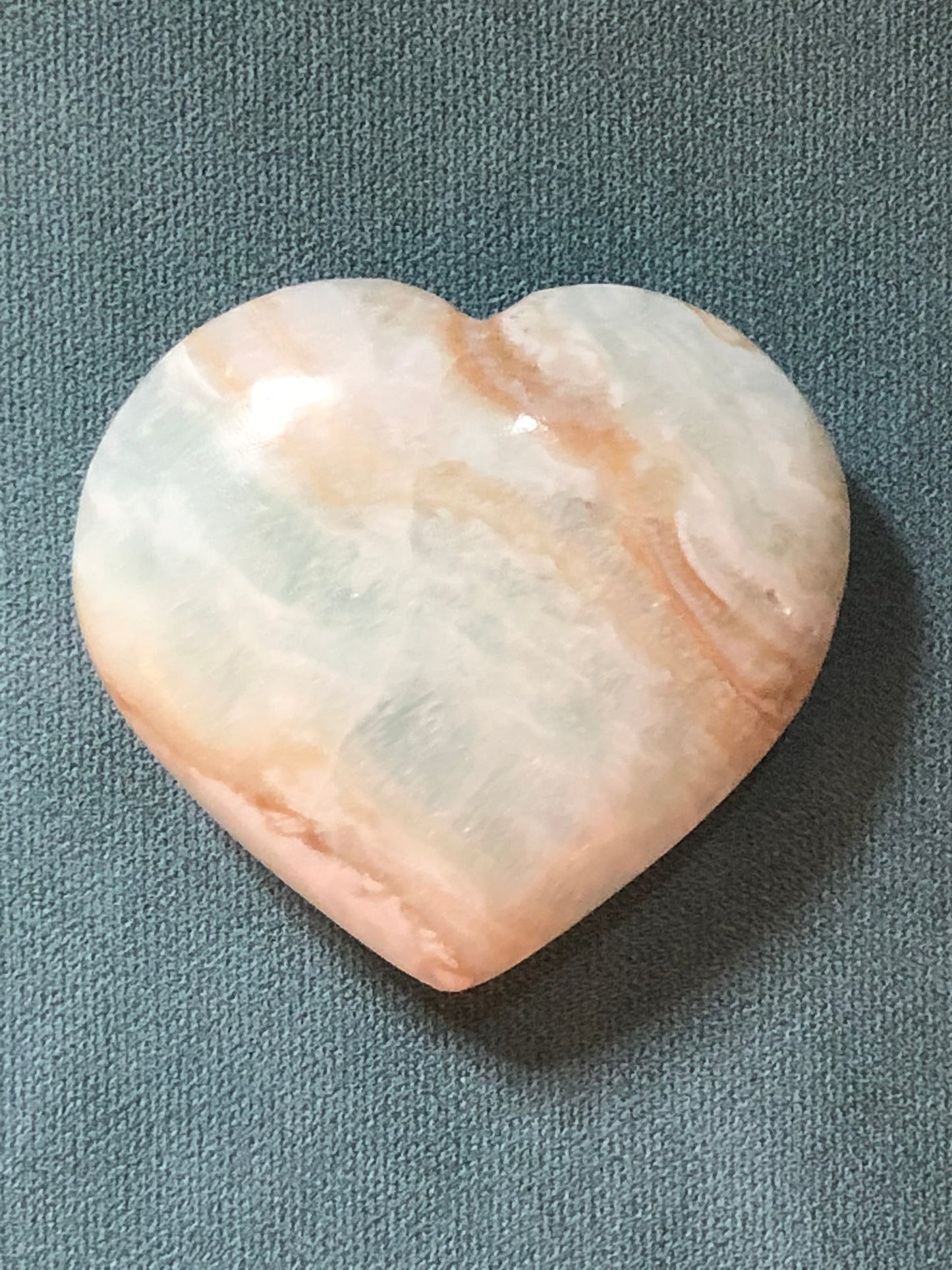 Medium sized Caribbean Calcite heart shaped palm stone.