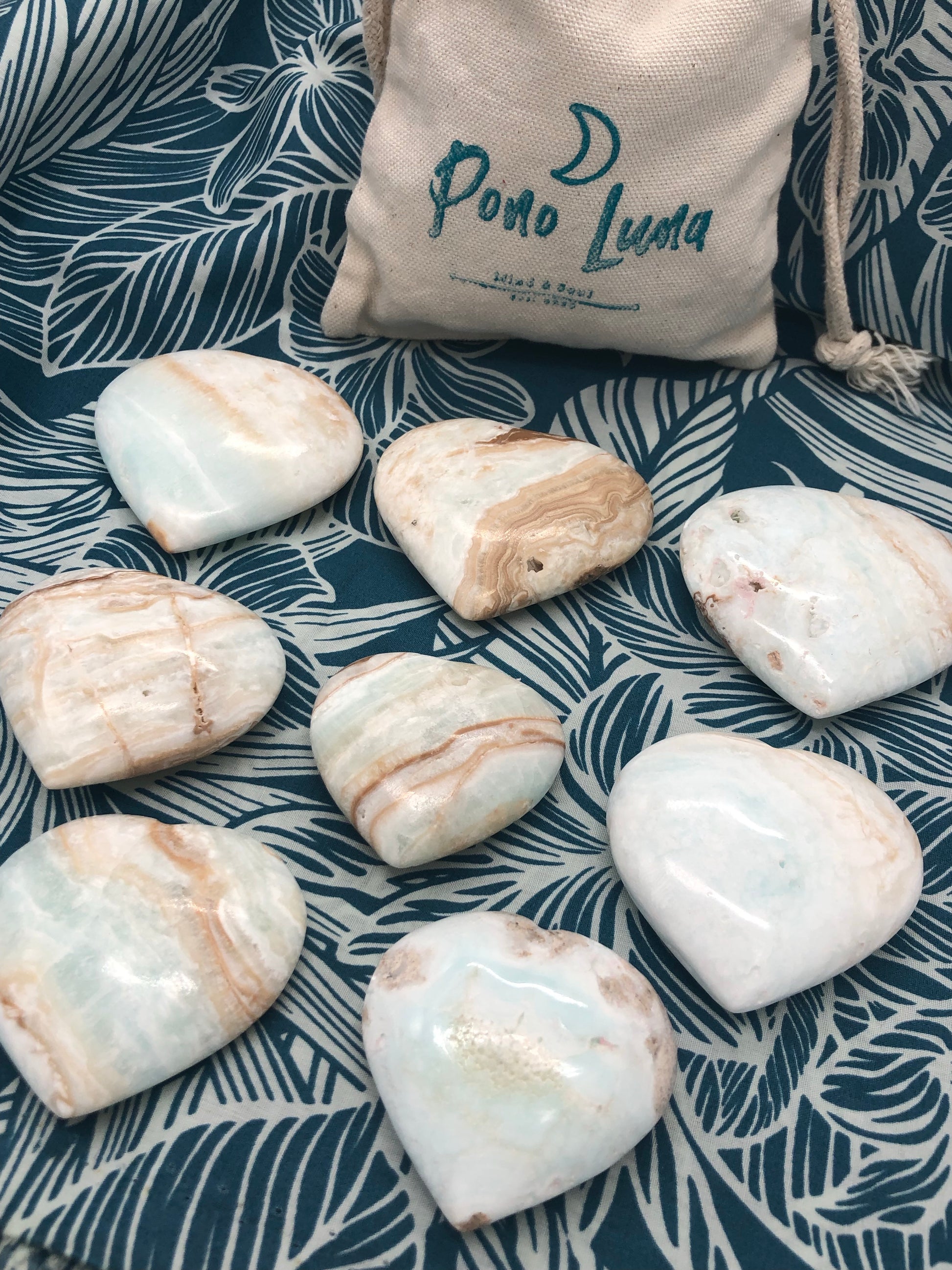 Pono Luna's beautiful hand carved and polished heart shaped Caribbean Calcite palm stones.